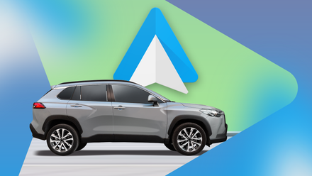 A silver SUV in front of the Android Auto logo on a green and blue geometric background