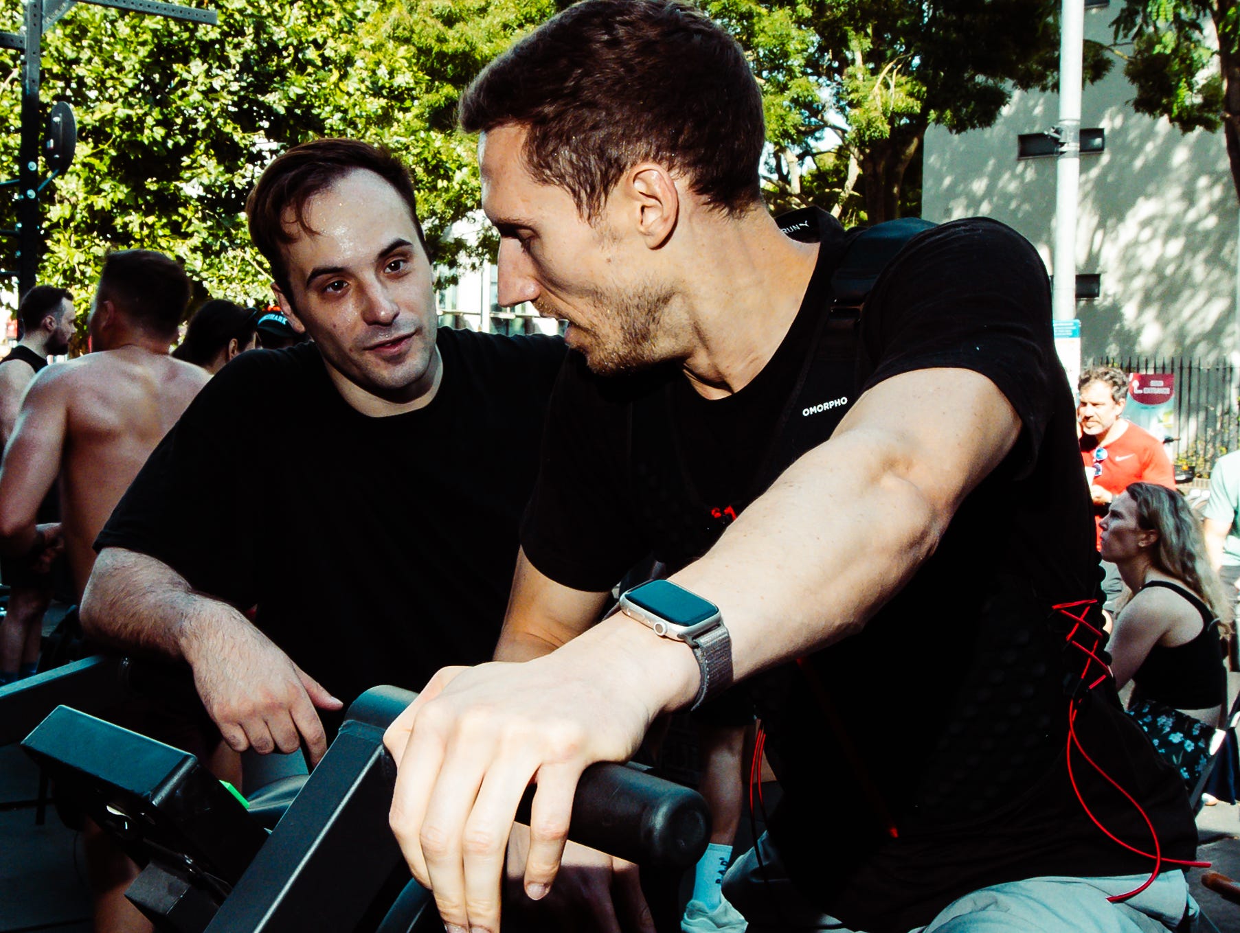 two men having a conversation during an outdoor cycling event. two men having a conversation during an outdoor cycling event.
