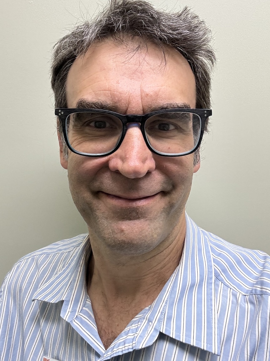 a man with grey hair smiling