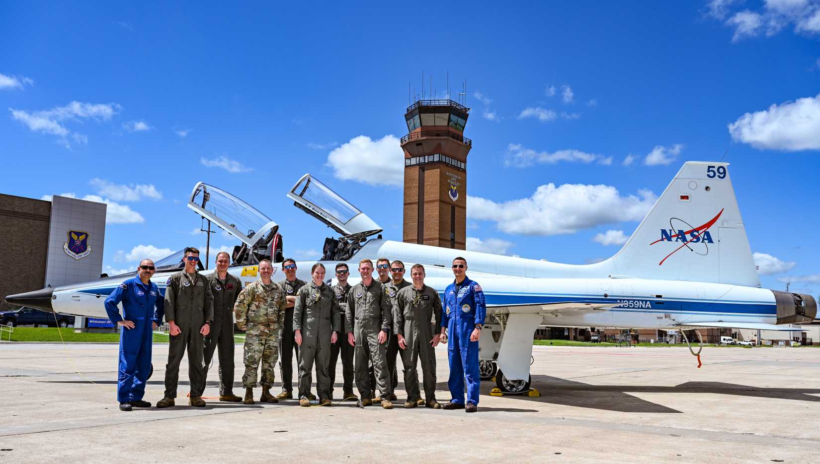 Air Force Airmen and NASA personnel discuss the T-38N Talon at Whiteman AFB
