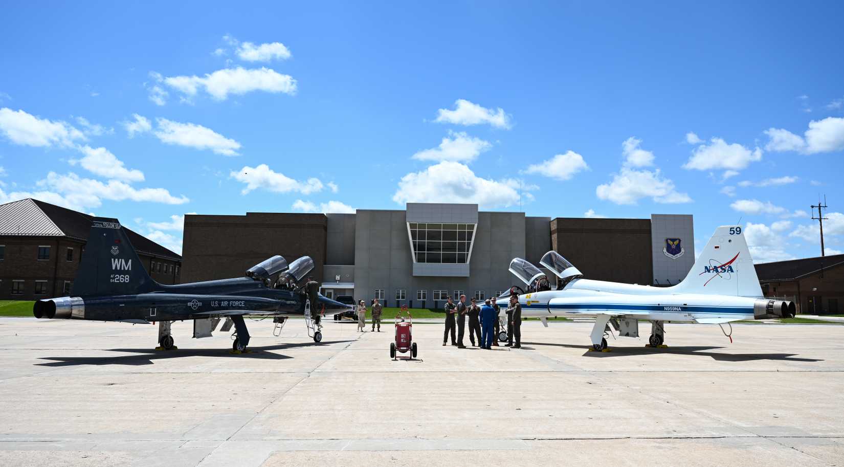 Air Force Airmen and NASA personnel discuss the T-38N Talon at Whiteman Air Force Base