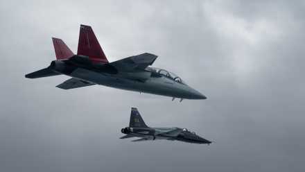 Air Force T-38 from the 560th Flying Training Squadron flies alongside a T-7A Red Hawk during the aircraft’s historic arrival to Air Education and Training Command at Joint Base San Antonio-Randolph, Texas, Dec. 3, 2025.