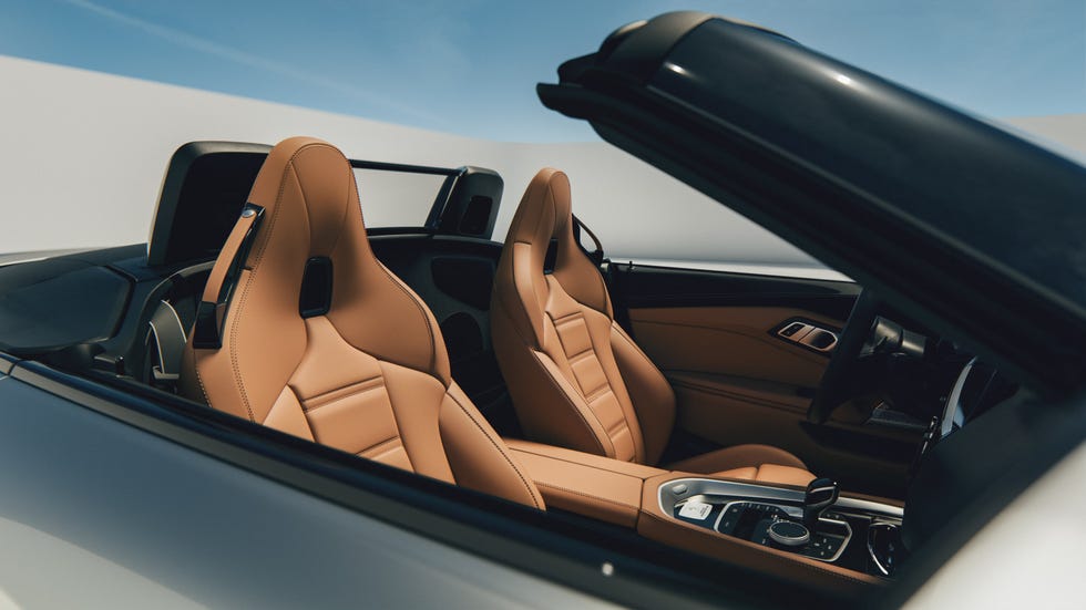 Interior view of a luxury convertible car with stylish tan leather seats and a modern dashboard. Interior view of a luxury convertible car with stylish tan leather seats and a modern dashboard.