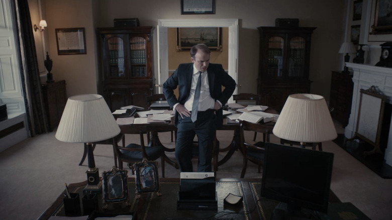 Rory Kinnear as Michael Callow leaning against table in Black Mirror