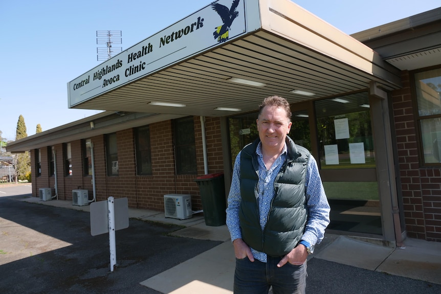 A doctor stands outside a regional medical centre.