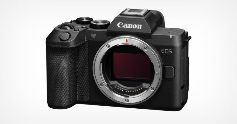 A black Canon EOS R8 Mark II mirrorless camera body shown from the front, featuring a lens mount, a textured grip, and a mode dial on top.