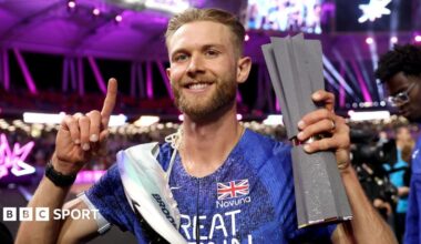 Josh Kerr celebrates with his Ultimate Championship trophy after winning the men's 1500m