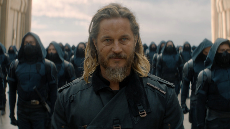 Travis Fimmel as Desmond standing in front of a hooded army in Dune: Prophecy