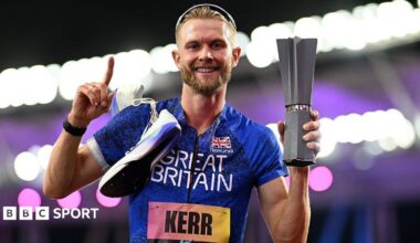 Josh Kerr celebrates while holding the 1500m trophy after winning the inaugural World Athletics Ultimate Champion event in Budapest, Hungary