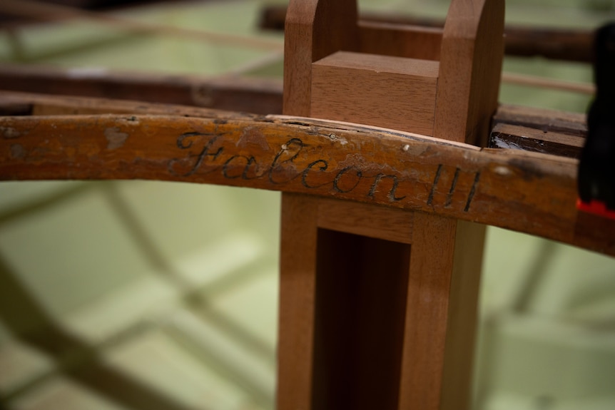 A wooden engraving closeup reading 'Falcon III'.