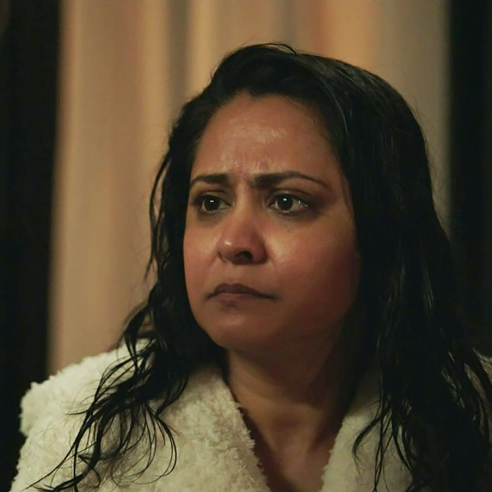 woman with wet hair looking serious, wearing a white robe indoors. woman with wet hair looking serious, wearing a white robe indoors.