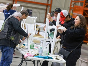 Volunteers cleaning and repairing crosses for the Field of Crosses