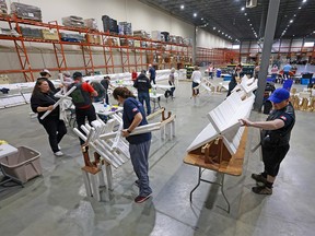 Volunteers cleaning and repairing crosses for the Field of Crosses