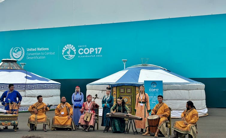 mongolian people sing and perform at pavilion space, blue background