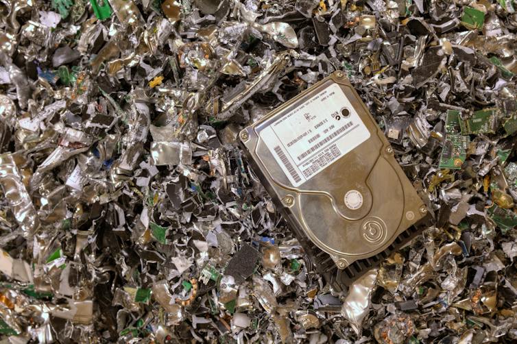 hard drive resting on shredded hard drives