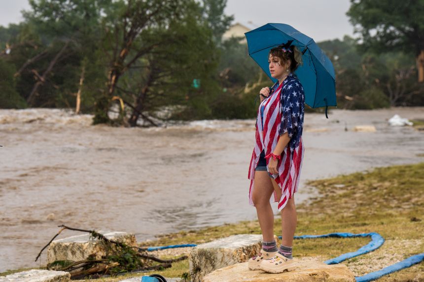 Kerrville resident Leighton Sterling watches flood waters along the Guadalupe River in Kerrville, Texas, on July 4, 2025.