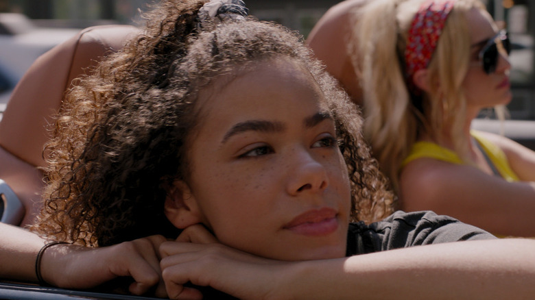 Ginny Miller looking wistful as she looks out from a convertible