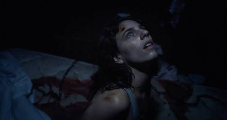 A woman in a dark camper in Hellcat