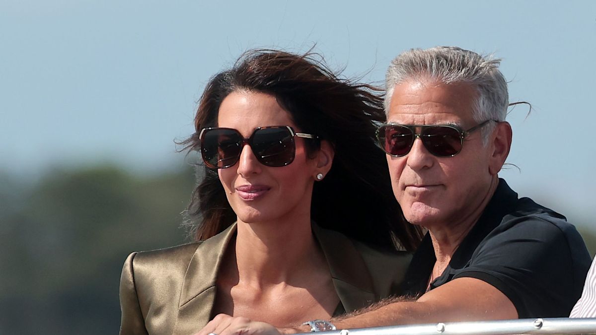 George and Amal Clooney look straight out of a romantic film as they arrive in Venice