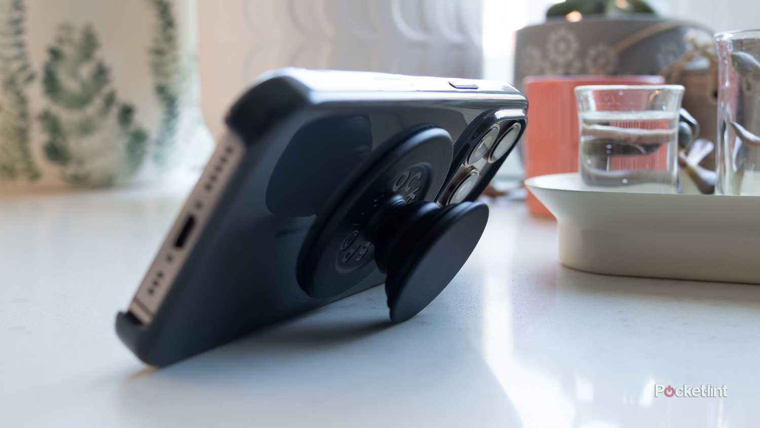 An iPhone 16 Pro with a MagSafe PopGrip and case.