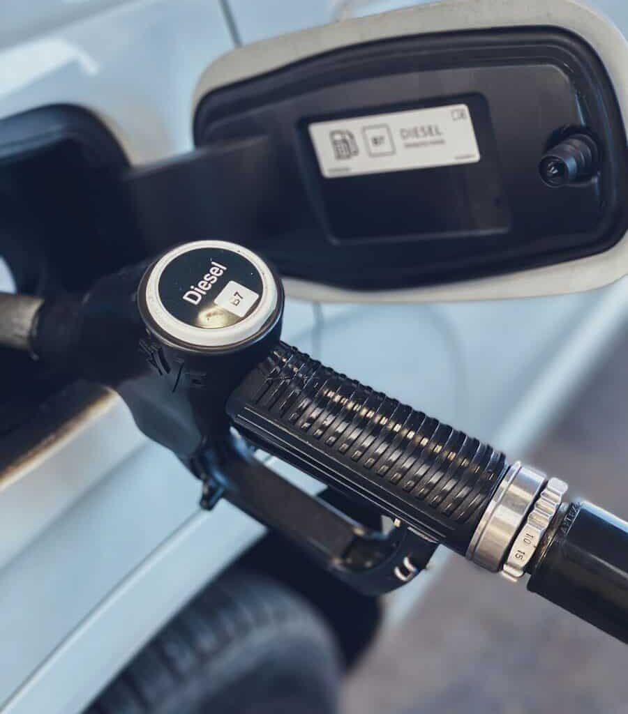 a close up of a gas pump with a car in the background