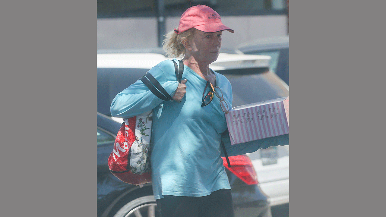 Linda Purl carrying a cake outside of a Gelson's store this week.