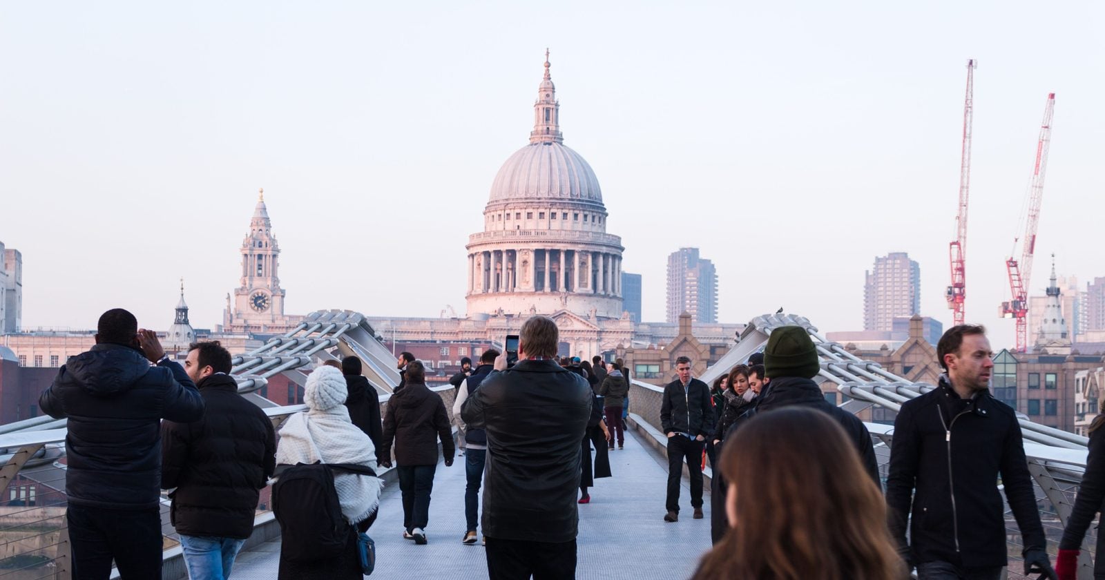 About 90,000 people crossed London's new Millennium Bridge on the day it opened in June 2000, with as many as 2,000 on the deck at once, and it swayed so badly it closed days later; subsequent work found that as few as 160 pedestrians could trigger the instability, and the fix was a system of dampers installed on the bridge.