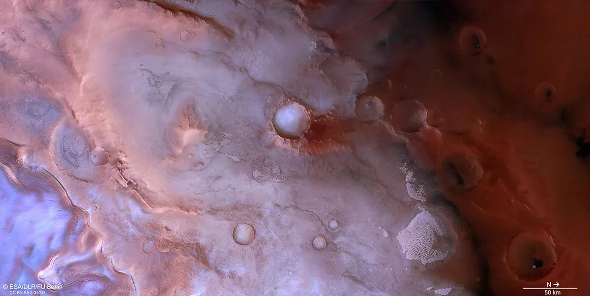 Swirls of purple, pink, and red near Mars’s south pole, imaged by ESA’s Mars Express.