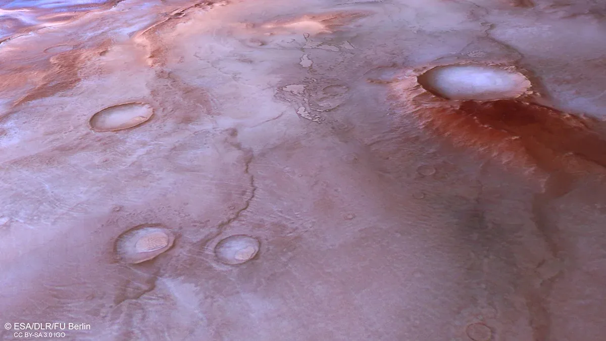 Thyles Rupes with visible craters, highlighting the rugged Martian landscape.