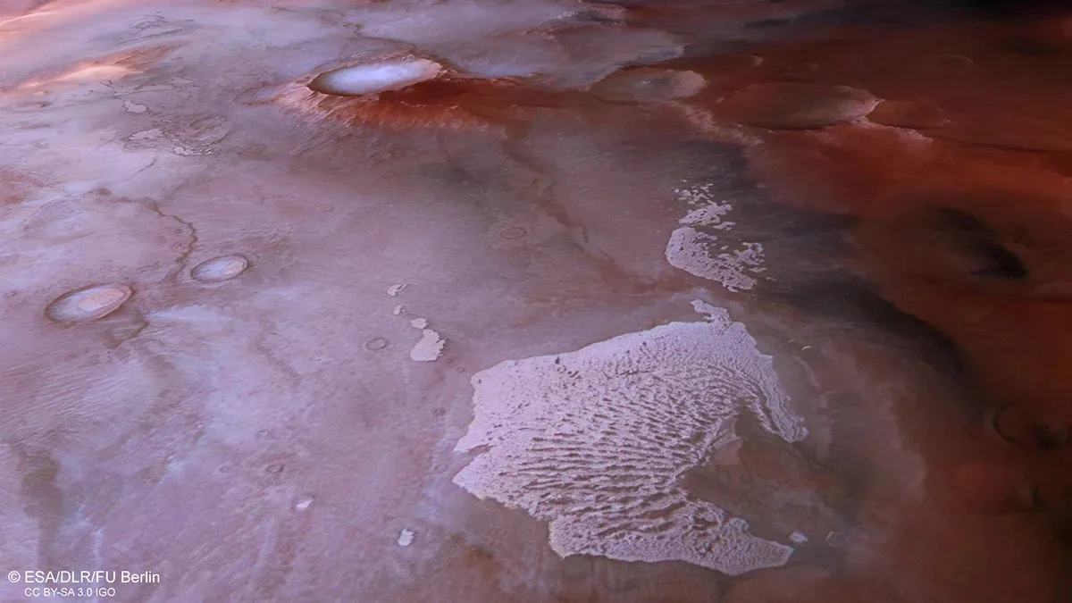 Ice-covered dunes near Thyles Rupes, showcasing seasonal Martian ice.