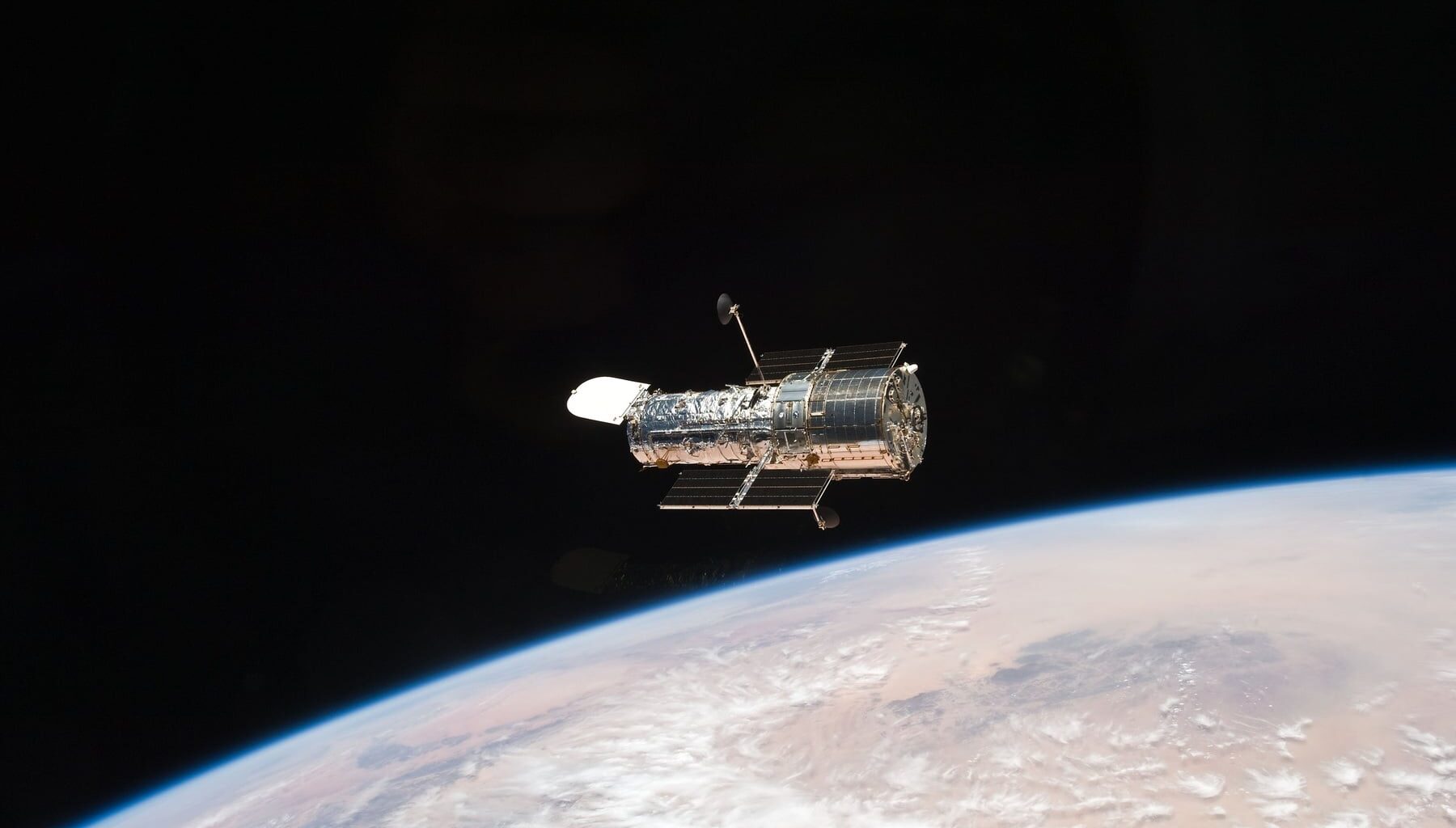 NASA's Hubble Space Telescope floating above Earth's curved horizon after STS-125