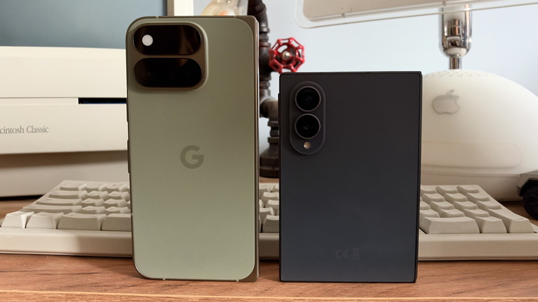 Google Pixel 11 Pro Fold and Samsung Galaxy Z Fold 8 stood next to each other on wood desk