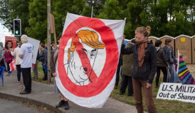 Shannon, Ireland, June. 5, 2019: Young women with a banner protesting against the Donald Trump visit at Shannon Airport, Ireland