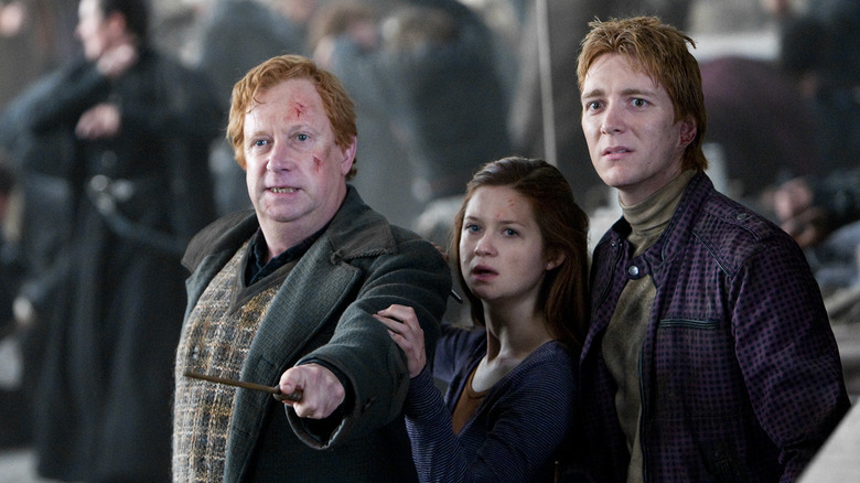 Arthur pointing his wand and protecting Ginny and George in Harry Potter and the Deathly Hallows: Part 2