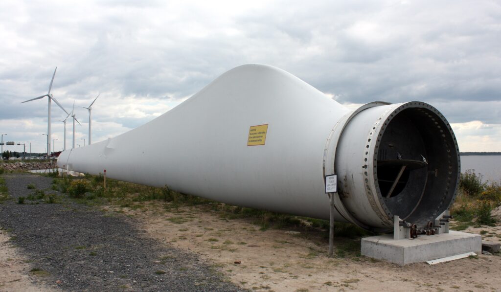 At Denmark’s Port of Aalborg, designers cut a retired wind-turbine blade into a curved roof that now shelters bicycles — a second life for the composite piece turbines can’t easily recycle