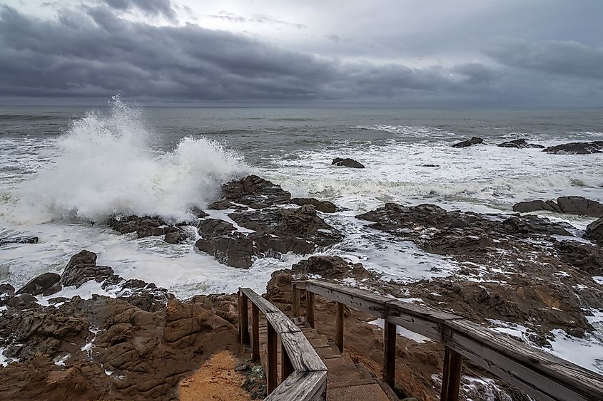 Heavy storm waves breaking on a Pacific coastline.