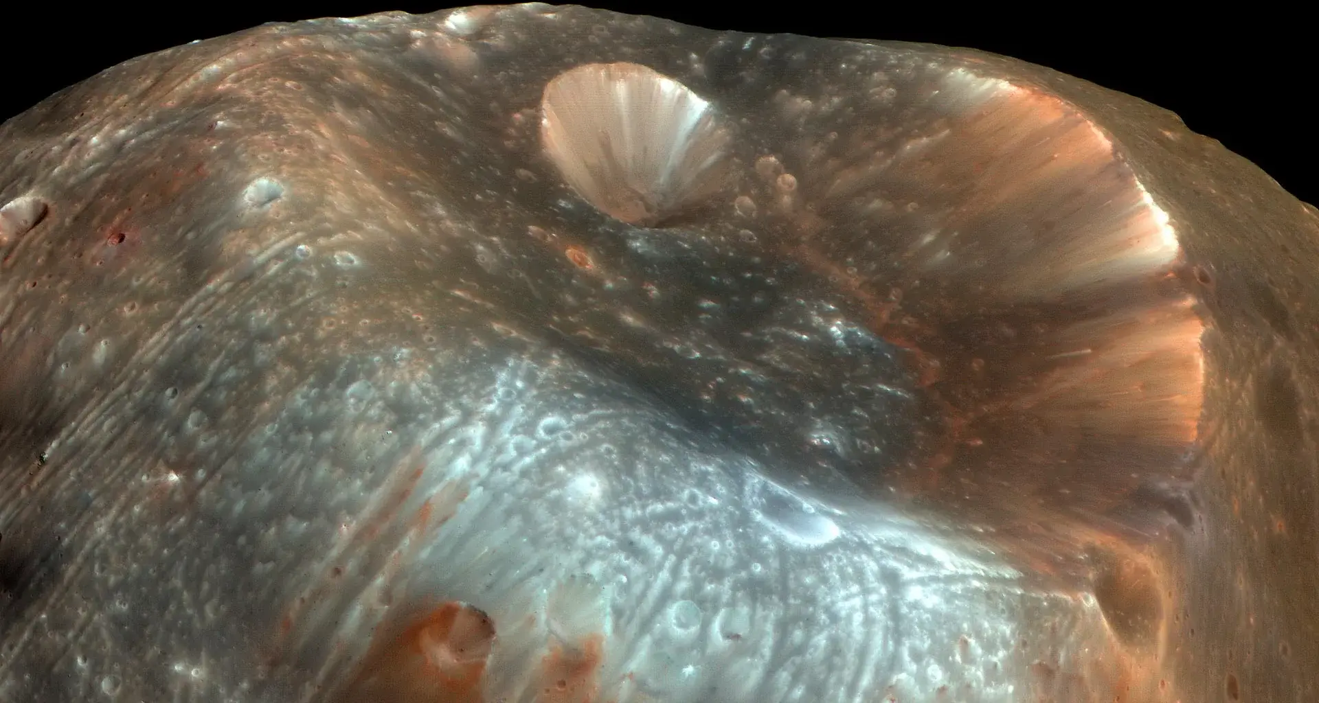 A giant crater may reveal the origin of Mars’ doomed moon