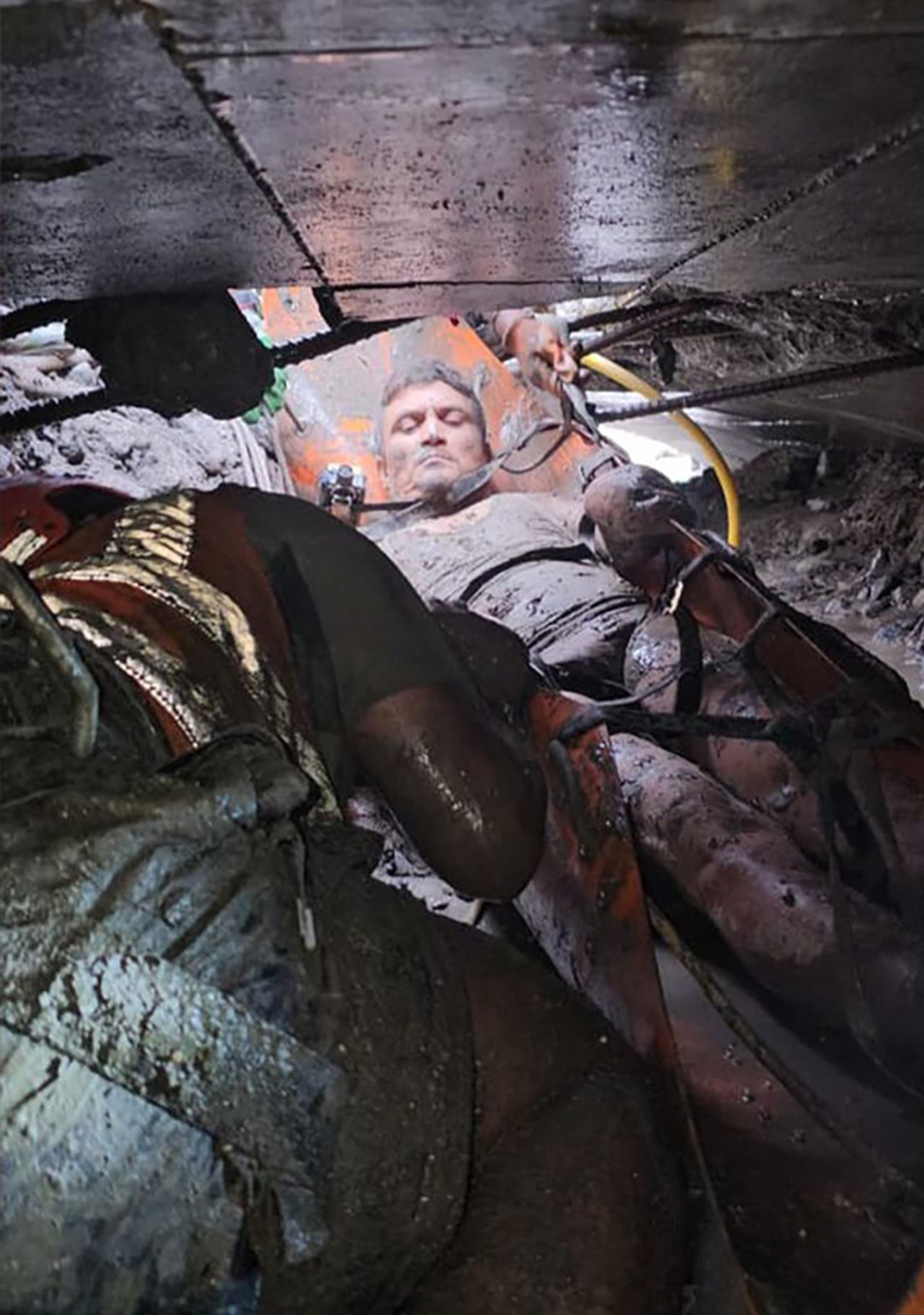 Rescue workers free a man who was trapped in a tunnel at the Trishuli 3A hydropower plant in Nepal on Friday.