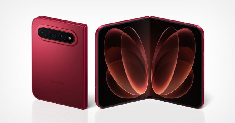 A red Xiaomi foldable smartphone shown from the back and in an open, unfolded position against a white background.