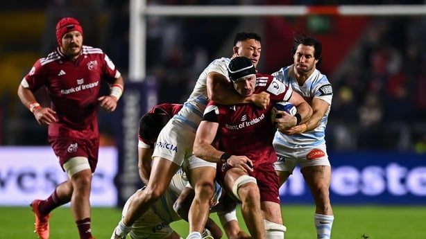 Tom Ahern of Munster is tackled by Joseph Manu, left, and Maxime Machenaud of Racing 92 - Champions Cup 2026