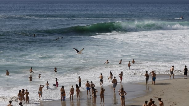 People gather along the La Jolla coastline after the National Weather Service issued a heat advisory for the coastal region on October 17, 2026 in San Diego