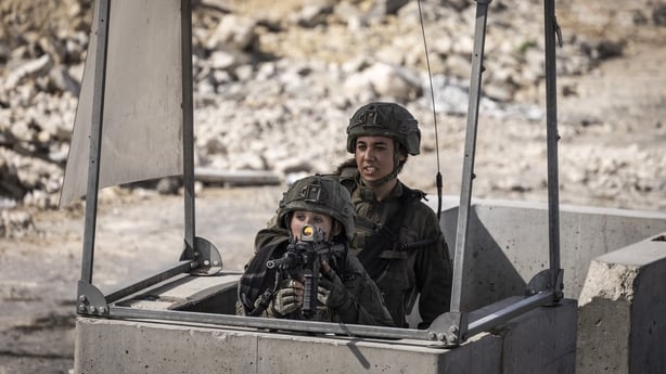 Israeli soldiers take aim from a blocked northern checkpoint in Hebron