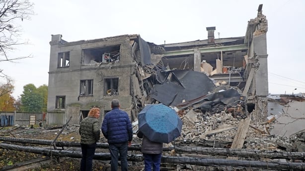 People face a building destroyed by a Russian ballistic missile strike, Kyiv, Ukraine.