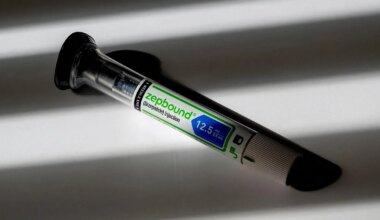 A photo of a Zepbound injection pen lying in shadows.