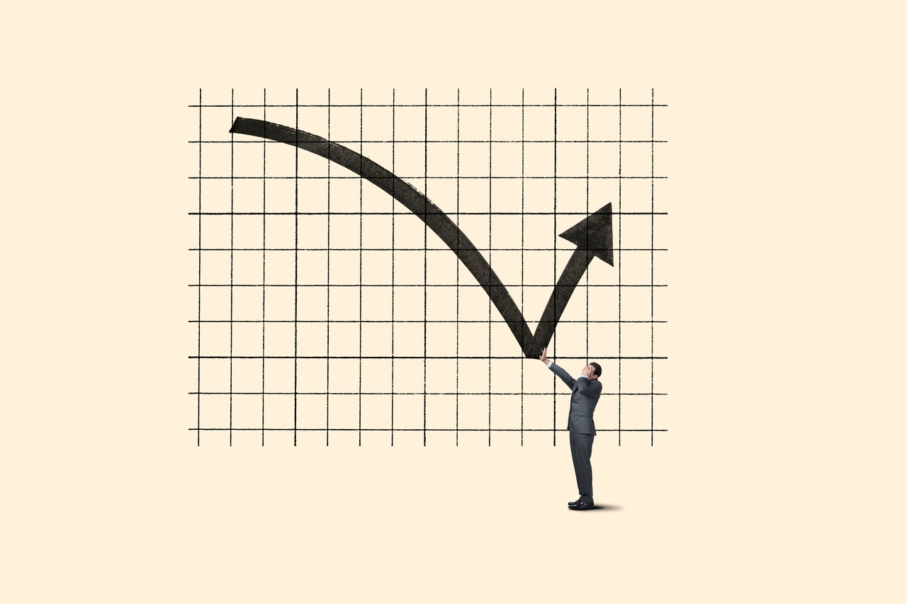 An investor pointing to a downward sloping arrow on a chart, showing the concept of "buy the dip" during a recession.