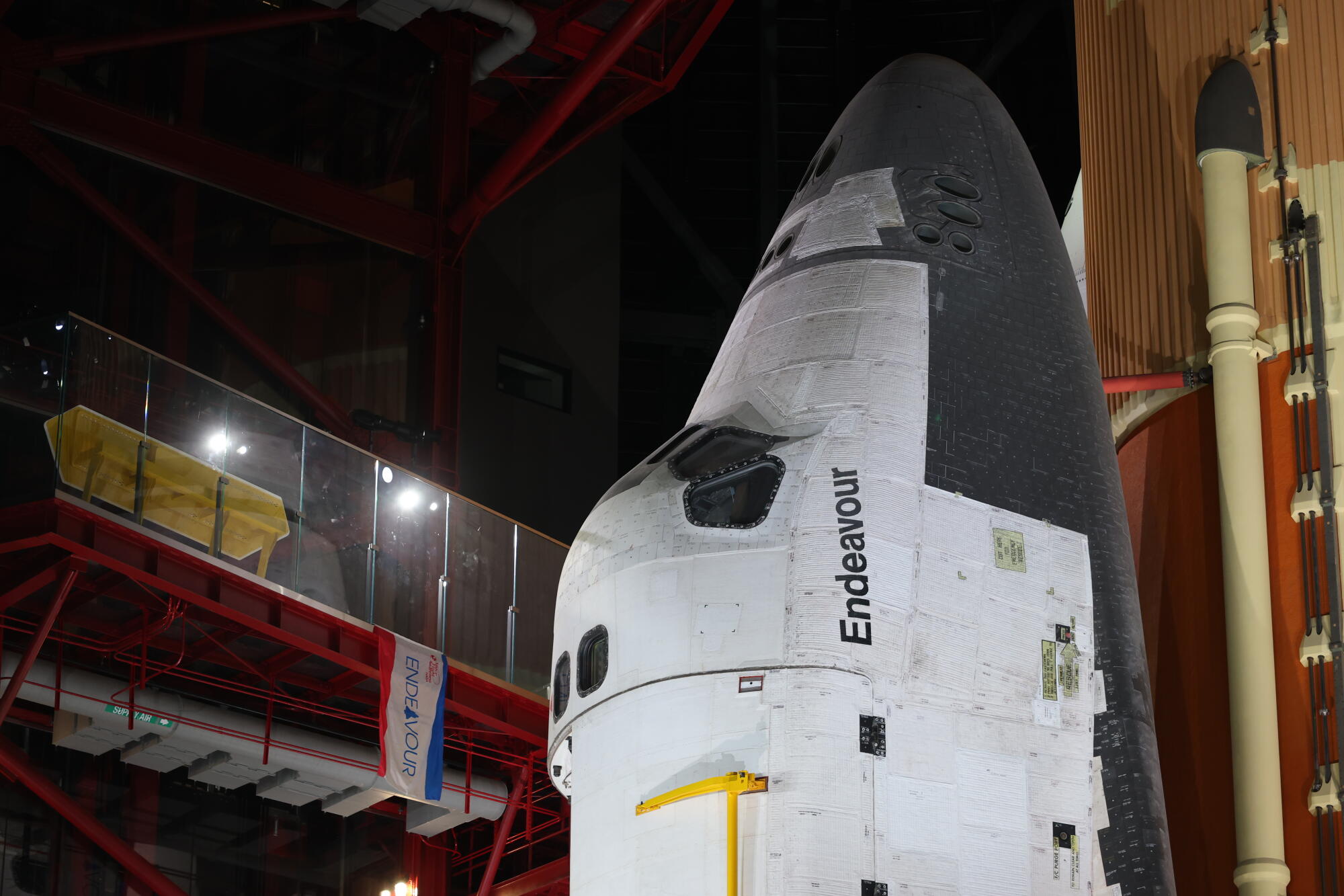 A space shuttle in a darkened exhibition room.