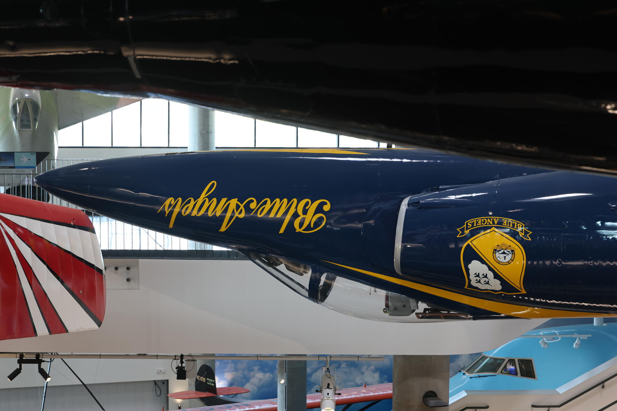 A plane hangs from the rafters of a museum.