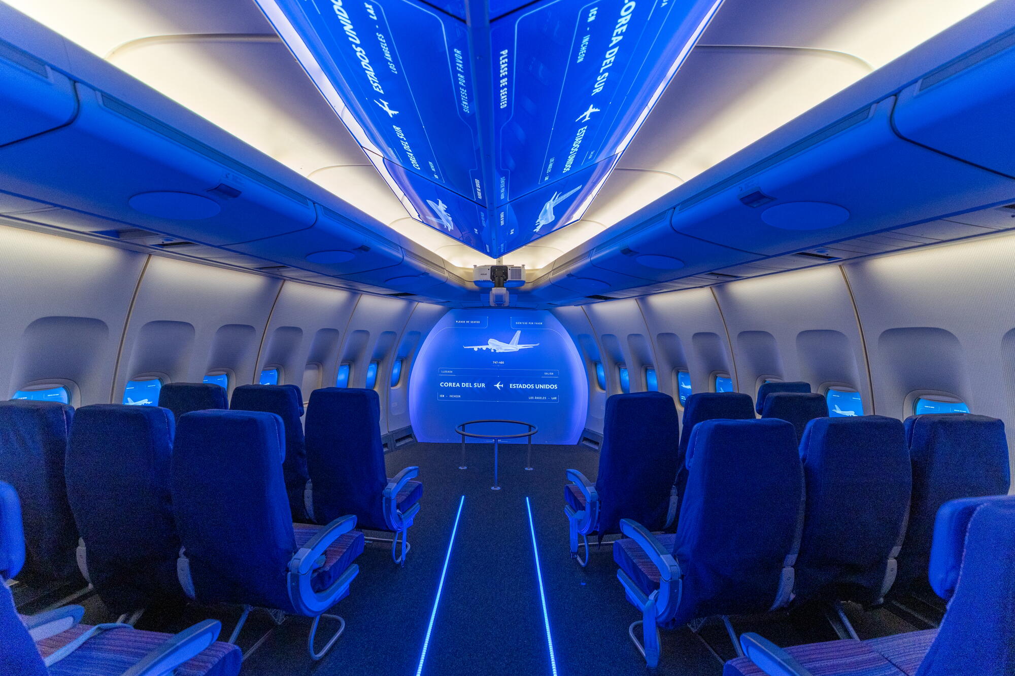 A section of a Boeing 747 is displayed inside a museum.
