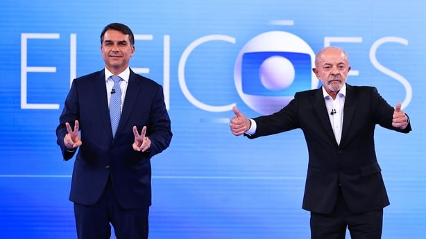 Flavio Bolsonaro, presidential candidate for the Partido Liberal and Luiz Inácio Lula Da Silva, incumbent president of Brazil pose for photographers before a debate 