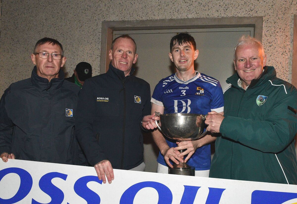Aghinagh captain Donagh O'Riordan accepts the Muskerry Junior A Football Championship Cup from Ed Warren, Chairman, Muskerry Junior GAA Board in the company of Concubhar Murray and Tim Holland, Ross Oil. Picture: John Tarrant 
